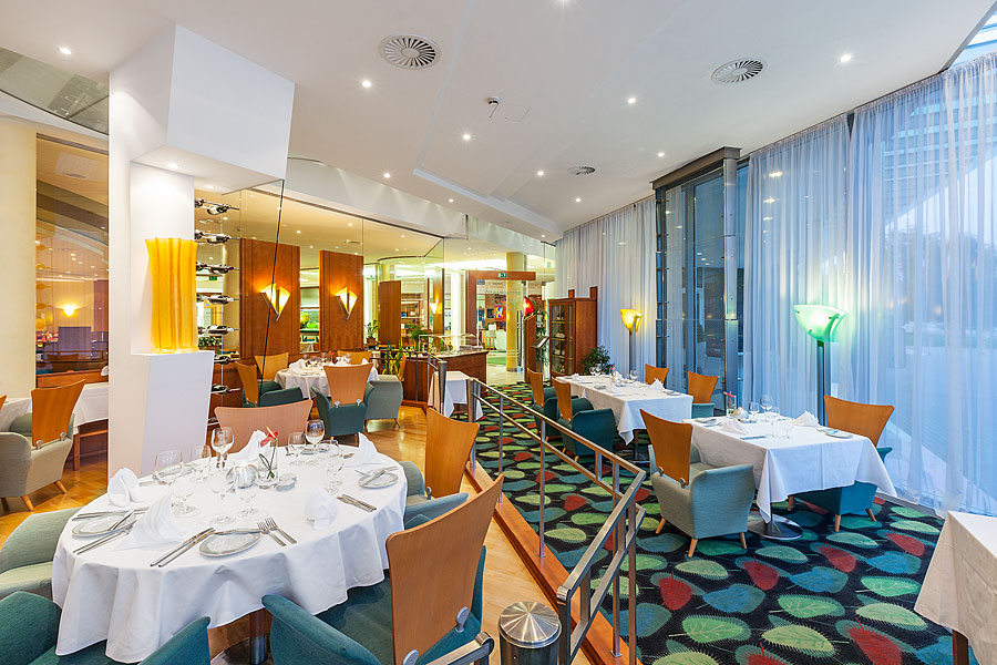 A restaurant with a colorful carpet in the Quality Hotel