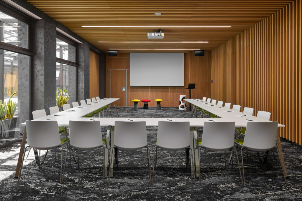 A conference room in the passage hotel with a u-shaped meeting arrangement