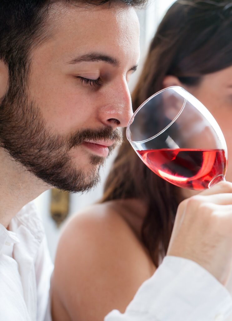 Man sniffing a glass of rose wine