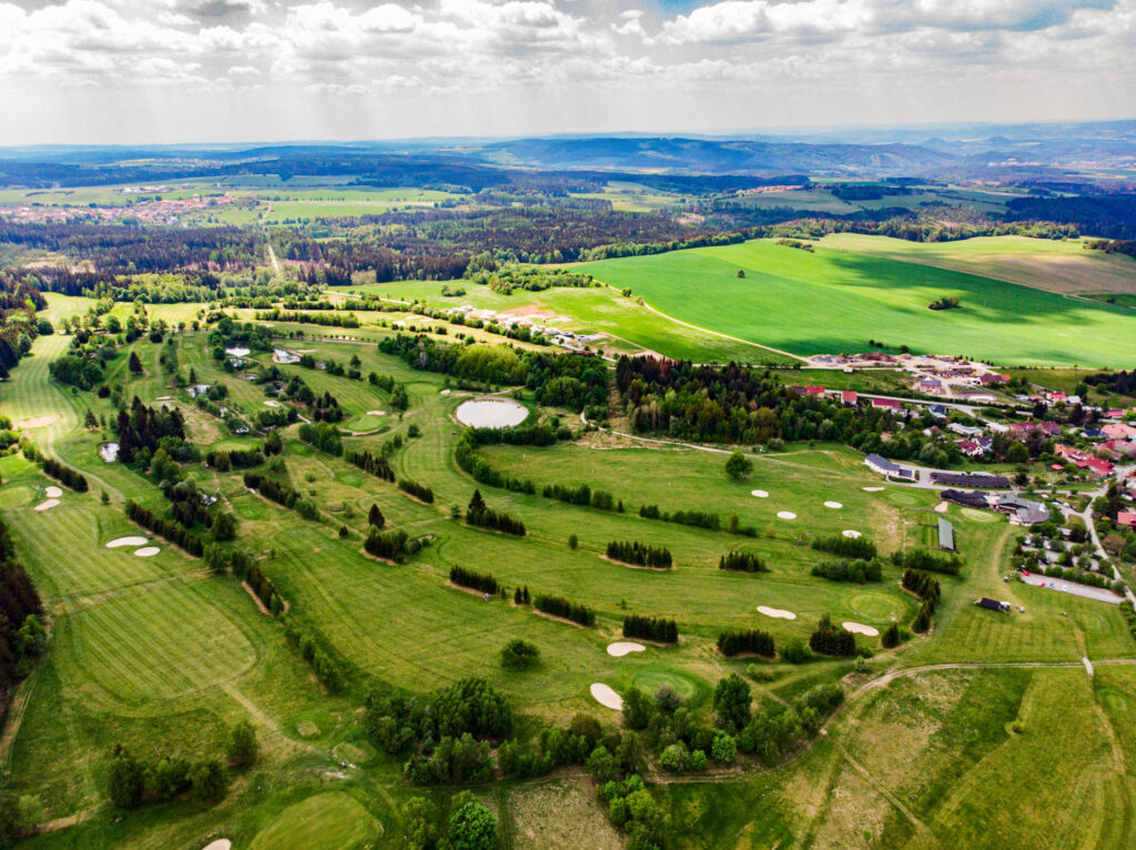 View of the golf course with trees in the Kořenov golf and ski resort