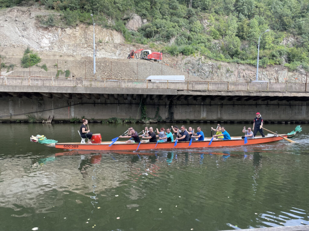 Sailing a dragon boat as part of team building around a concrete wall