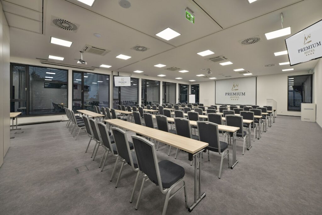 A conference room with a school-style arrangement in the Premium Hotel Znojmo