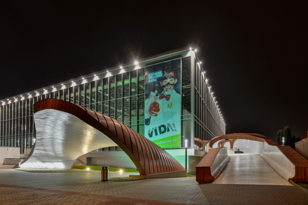 View of the exterior of the Vida Science Center from the exhibition grounds at night