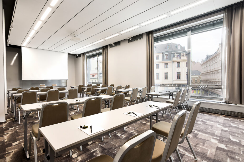 A conference room in the Best Western International hotel with a school-style meeting arrangement from the side with a view from the window