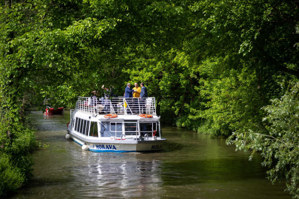 Cruise on a boat along the Bata Canal under the trees surrounding the canal