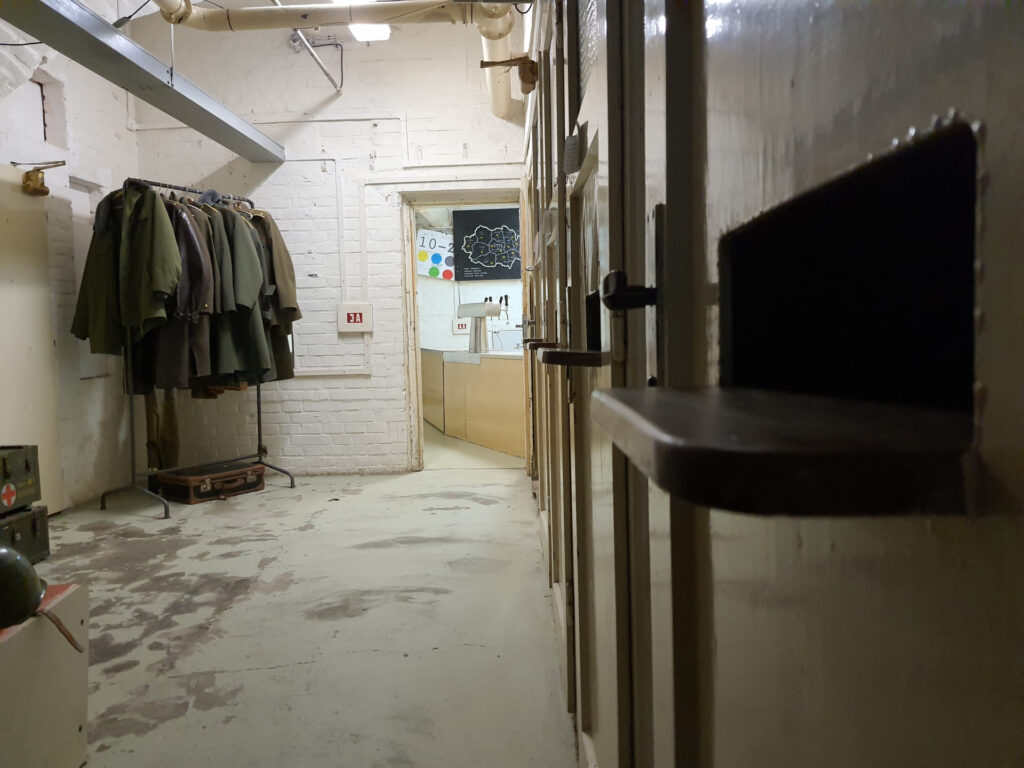 Bunker 10-z area with hanging green coats and doors