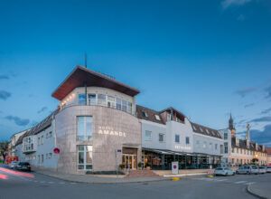 Evening view of the Amande hotel building from the street