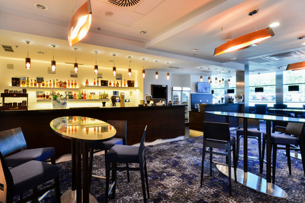 Bar in Hotel Grid with seating, armchairs and bar stools