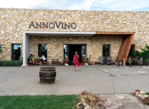 Exterior Annovino view of the entrance with a woman in a red dress