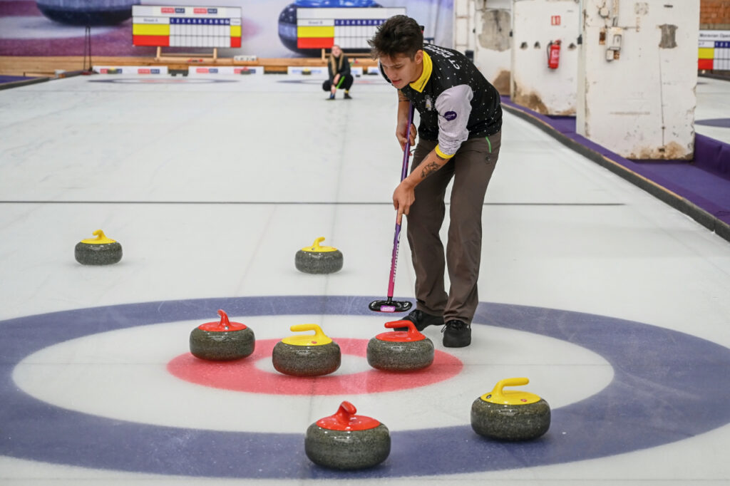 Player in the middle of circle at the end of the curling rink