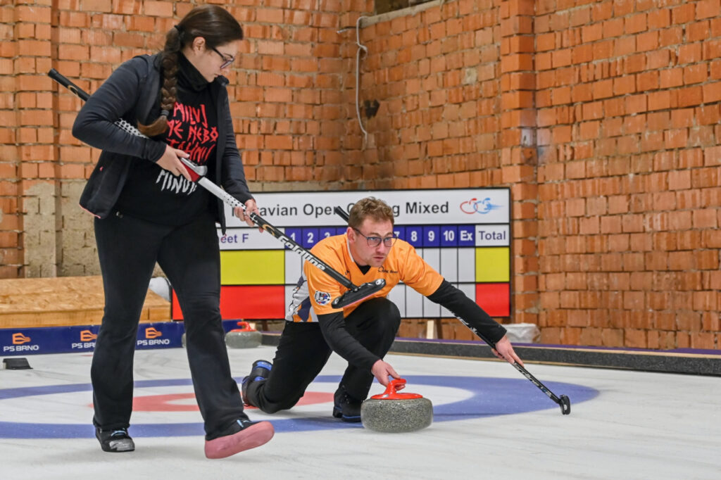 Two people starting the game of curling