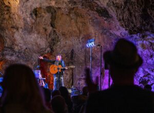 A member of the music band in the cave